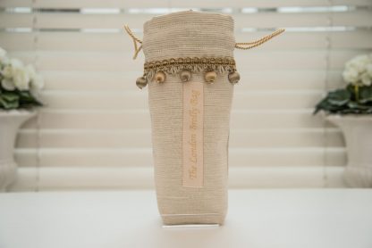 Textured cream brolly bag with gold
